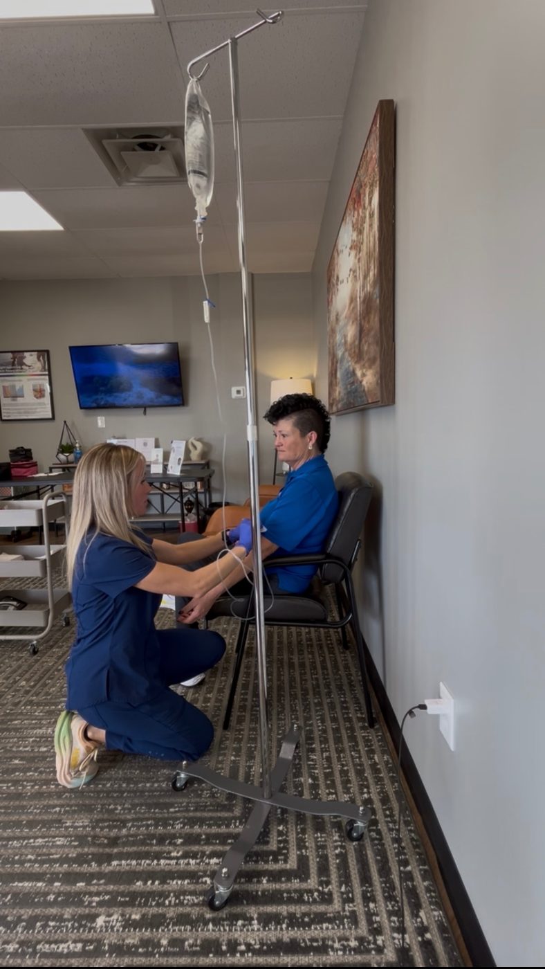 Registered nurse starting an IV infusion on site